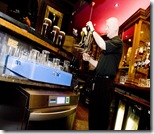 Ian Hickey uses a clean glass to pull a pint at The Botanic Inn, Belfast